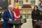 President Donald Trump speaking at a podium with Tulsi Gabbard standing nearby in the Oval Office.
